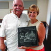 Peggy Steinbeck with a gift she received at her retirement reception. She is pictured with one of her many friends, Jeff Metcalf. Peggy had her picture taken with everyone who attended the party in her honor.