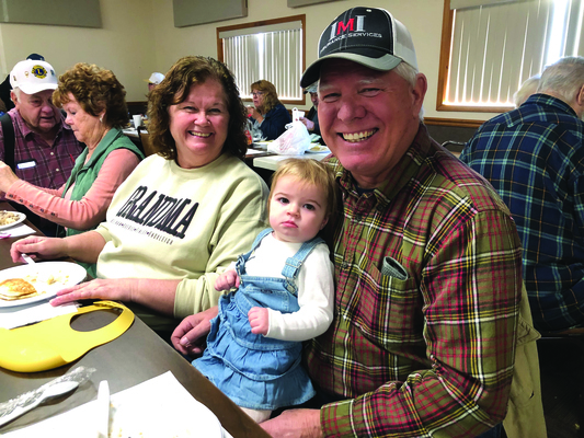 Kent and Angie Stahl of Camp Point, Ill., with their granddaughter.