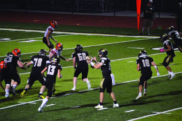 Drew Mallett #15 getting ready to hand the ball to Cameron Bringer #13.  Also pictured is Blake Kaylor #63, Cole Lair #78, Toby O’Brien #68, Robert Goehl #18, Brandon Holder #81, and Devin Stutsman #23.