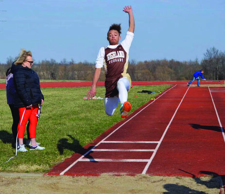 Brandon Holder jumping in the long jump.