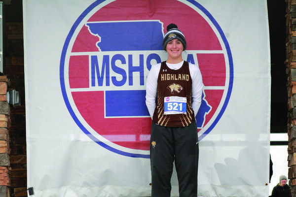 Kaycie Stahl after the race in front of the MSHSAA sign.